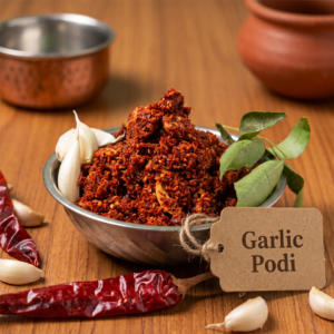 Bowl of garlic podi with rustic tag and fresh garlic cloves